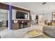 Modern living room with a large TV, stylish decor and open floor plan at 10012 Sage Creek Dr, Ruskin, FL 33573