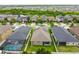 Aerial view of a house with solar panels, a pool, and a fenced yard at 10012 Sage Creek Dr, Ruskin, FL 33573