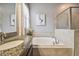 Bathroom features granite countertop, oval sink, and garden tub at 10012 Sage Creek Dr, Ruskin, FL 33573
