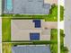 Aerial view of a house with solar panels and a pool in a residential area at 10012 Sage Creek Dr, Ruskin, FL 33573
