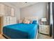 Bedroom with a blue bedspread and white dresser at 10012 Sage Creek Dr, Ruskin, FL 33573