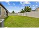 Large backyard with a privacy fence and green lawn at 10012 Sage Creek Dr, Ruskin, FL 33573