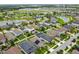Aerial view of a neighborhood with houses, a lake and lush green areas at 10012 Sage Creek Dr, Ruskin, FL 33573