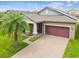 One-story home with solar panels and a two-car garage at 10012 Sage Creek Dr, Ruskin, FL 33573
