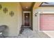 Welcoming front entry with a red door and decorative lanterns at 10012 Sage Creek Dr, Ruskin, FL 33573