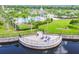 Community fire pit and seating area overlooking a lake at 10012 Sage Creek Dr, Ruskin, FL 33573