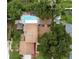 Aerial view showing house, pool, and lush landscaping at 1606 Alder Way, Brandon, FL 33510