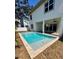 Backyard pool with covered patio, ceiling fans, and sliding glass doors to inside at 4021 W Santiago St, Tampa, FL 33629