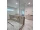 Bathroom showing walk-in shower with marble wall tile and large vanity with dual sinks at 4021 W Santiago St, Tampa, FL 33629