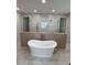 Elegant bathroom featuring a freestanding tub, walk-in shower, and luxurious finishes for a spa-like experience at 4021 W Santiago St, Tampa, FL 33629