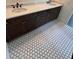 Elegant bathroom with dual sinks, dark wood cabinets, and decorative tile flooring, adding a touch of sophistication at 4021 W Santiago St, Tampa, FL 33629