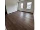 Empty bedroom features hardwood floors, two windows, and neutral paint, providing a blank canvas at 4021 W Santiago St, Tampa, FL 33629