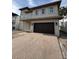 Two-story home featuring a two-car garage and a brick paver driveway at 4021 W Santiago St, Tampa, FL 33629