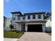 New two-story home features a brick-paver driveway, a two-car garage and a well-manicured lawn at 4021 W Santiago St, Tampa, FL 33629