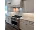 Spacious kitchen features stainless steel appliances, light gray cabinets and decorative backsplash at 4021 W Santiago St, Tampa, FL 33629