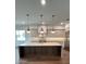 Contemporary kitchen with large island, stainless steel appliances, and pendant lighting at 4021 W Santiago St, Tampa, FL 33629