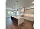 Modern kitchen with large center island, stainless steel appliances and hardwood flooring at 4021 W Santiago St, Tampa, FL 33629