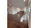 Open concept living room with hardwood floors, large windows, and modern lighting at 4021 W Santiago St, Tampa, FL 33629