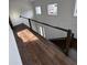 Modern stairway with hardwood flooring and a sleek railing, leading to the upper level of the home at 4021 W Santiago St, Tampa, FL 33629