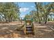 playground with slide and swings, set amongst mature trees at 13265 Great Plains Dr, Riverview, FL 33579