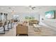 Bright living room with sofas, a large TV, and access to the kitchen at 13265 Great Plains Dr, Riverview, FL 33579