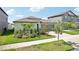House exterior showcasing a two-car garage and landscaping at 13265 Great Plains Dr, Riverview, FL 33579