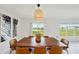 Dining room with a wooden table, neutral decor and view of the lake at 13265 Great Plains Dr, Riverview, FL 33579