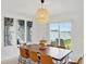 Modern dining room with sliding glass doors leading to the backyard at 13265 Great Plains Dr, Riverview, FL 33579