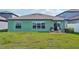 Backyard with patio and grassy area at 13265 Great Plains Dr, Riverview, FL 33579