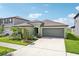 House exterior featuring a two-car garage and landscaping at 13265 Great Plains Dr, Riverview, FL 33579