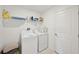 Well-lit laundry room with washer, dryer, and storage shelves at 13265 Great Plains Dr, Riverview, FL 33579