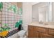 Bathroom with shower/tub combo and wood vanity at 8834 Sanders Tree Loop, Wesley Chapel, FL 33545