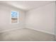 Well-lit bedroom with neutral walls and carpeted floors at 8834 Sanders Tree Loop, Wesley Chapel, FL 33545