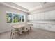 Bright breakfast nook with a wooden table and view to the backyard at 8834 Sanders Tree Loop, Wesley Chapel, FL 33545