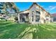 House with a screened-in patio and lush green backyard at 11416 Billingham Blvd, Spring Hill, FL 34609