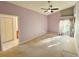Neutral primary bedroom with a ceiling fan, carpeted floors and a walk-in closet at 11416 Billingham Blvd, Spring Hill, FL 34609