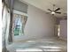 Large bedroom with ceiling fan and backyard view at 11416 Billingham Blvd, Spring Hill, FL 34609
