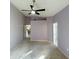 Bedroom with neutral walls, carpet and ceiling fan and two doors leading to other rooms at 11416 Billingham Blvd, Spring Hill, FL 34609