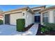 Charming single-story home with a well-maintained front yard, two car garage, and tiled walkway to the front door at 11416 Billingham Blvd, Spring Hill, FL 34609