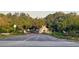 Gated community entrance with lush landscaping and a guard house at 11416 Billingham Blvd, Spring Hill, FL 34609