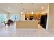 Kitchen with light wood cabinets, black appliances, and breakfast bar at 11416 Billingham Blvd, Spring Hill, FL 34609