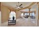 Spacious living room with a ceiling fan and views of the outdoor living space at 11416 Billingham Blvd, Spring Hill, FL 34609