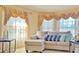 Living room featuring a comfy couch and elegant window treatments at 11416 Billingham Blvd, Spring Hill, FL 34609