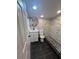 Bathroom with white vanity, marble shower, and dark tile floors at 5238 16Th St, Zephyrhills, FL 33542