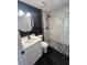Bathroom with white vanity, marble shower, and dark tile floors at 5238 16Th St, Zephyrhills, FL 33542