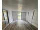 Bright Florida room with wood-look flooring and sliding glass doors at 5238 16Th St, Zephyrhills, FL 33542