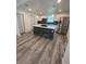 Modern kitchen with white cabinets, stone island, and new flooring at 5238 16Th St, Zephyrhills, FL 33542