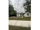 Charming house with white exterior, landscaping, and walkway at 5238 16Th St, Zephyrhills, FL 33542