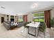 Open living space with hardwood floors, a dining area, and access to the backyard at 212 Excalibur Ct, Brandon, FL 33511