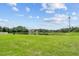 Large backyard with a pond view and lush grass at 212 Excalibur Ct, Brandon, FL 33511